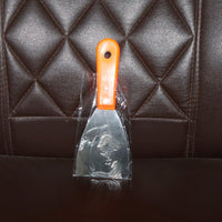 Putty knife with a comfortable soft rubber handle and a hanging hole for easy storage.