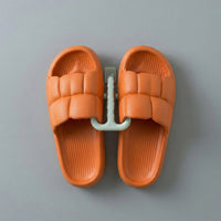 Wall mounted slipper holder in bathroom setting