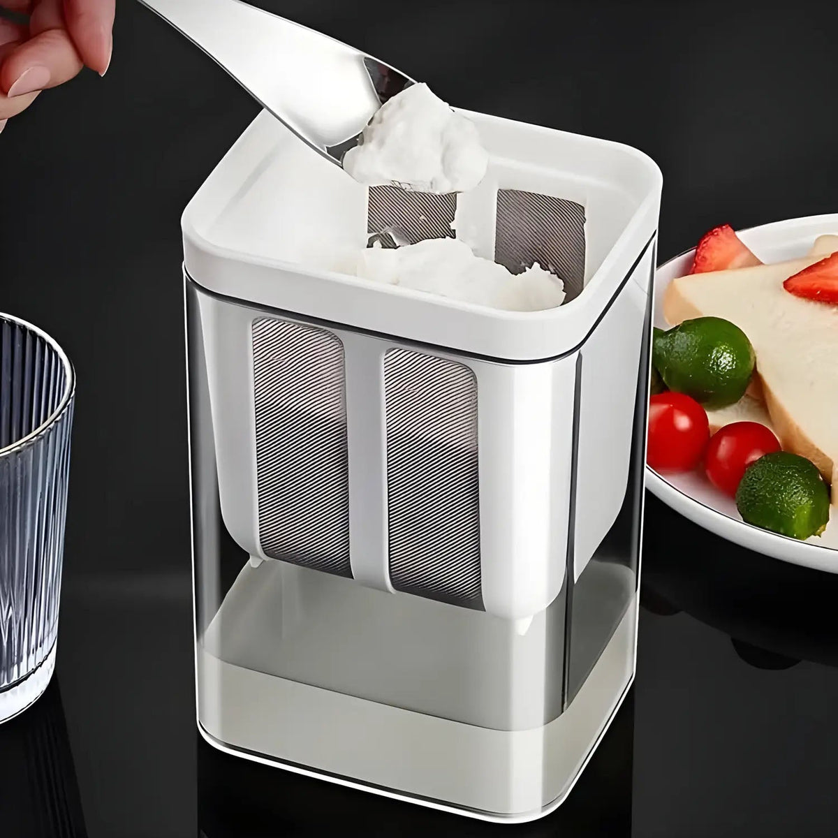 Yogurt maker filtering container showing whey separation for thick Greek yogurt.