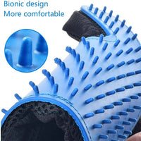 A hand wearing the pet deshedding glove gently grooming a dog's fur.