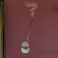 Wall-mounted agarbatti holder in silver mounted inside pooja room