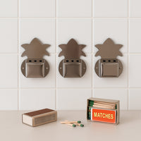 Close-up of metal wall-fixed incense stick holder showing ash collection tray.