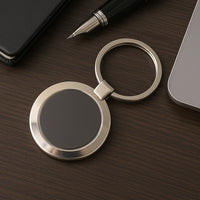 Durable round metal keychain with strong alloy build and black center.