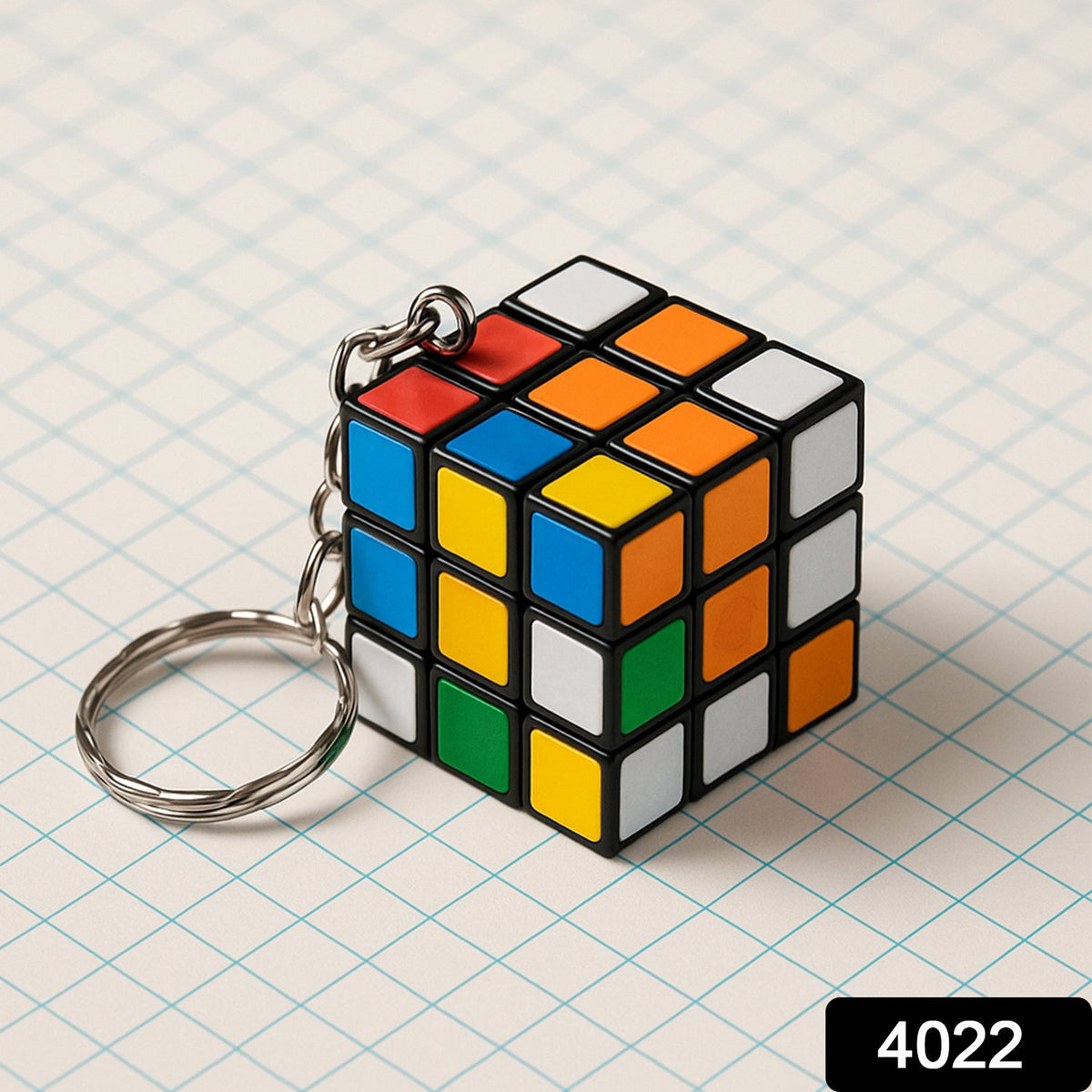 Hand holding a compact Mini Magic Cube Puzzle keychain, ready for play.